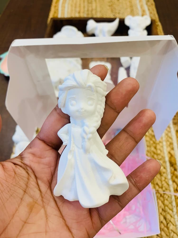 Unpainted white princess figurine held in hand
