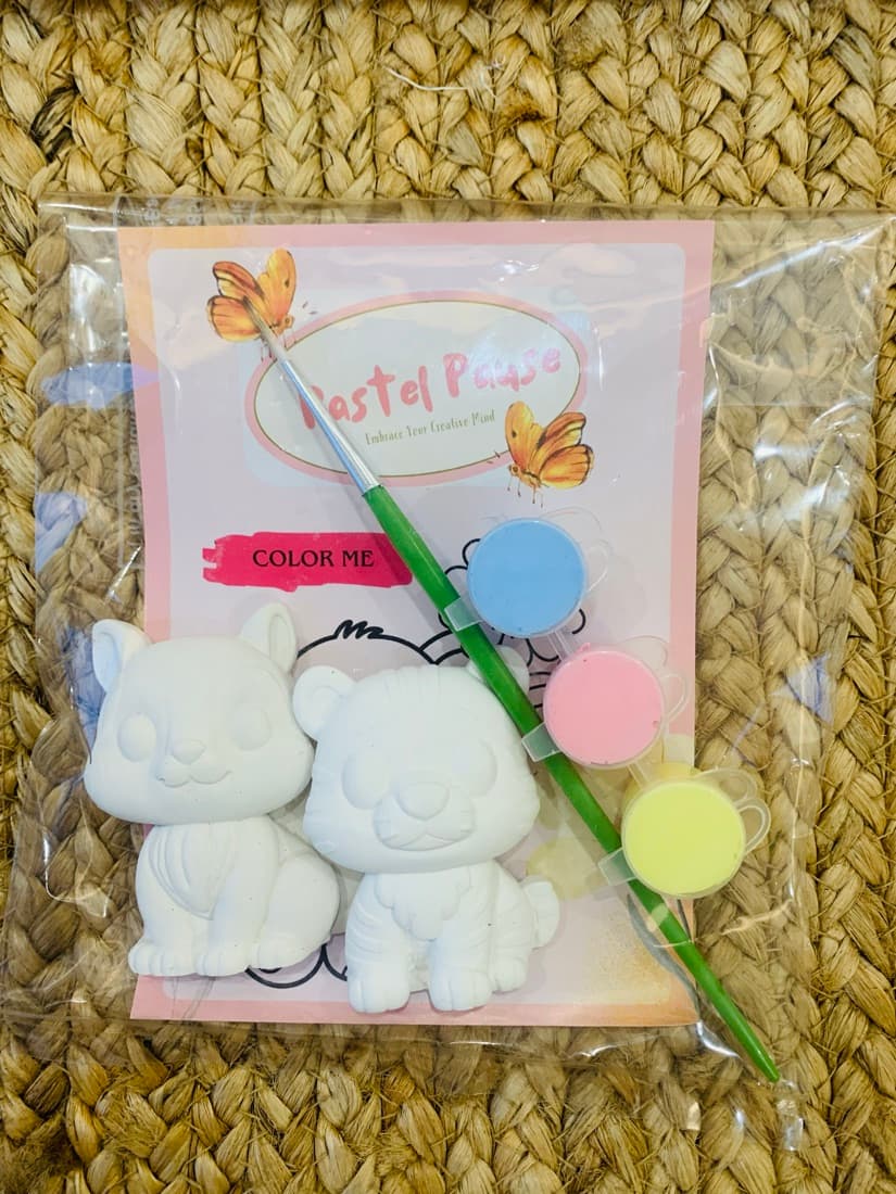 Pastel Pause pouch kit with two figurines, a brush and three pastel paint pots