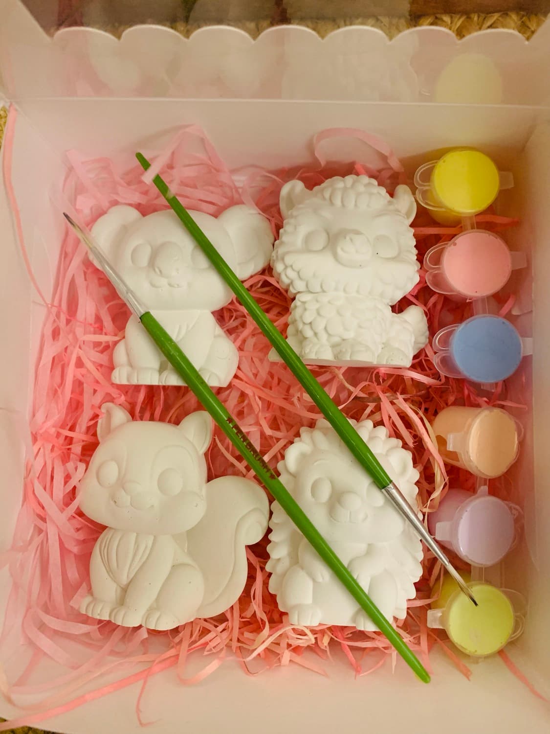 Pastel Pause gift box with white figurines, pastel paint pots and brushes nestled in pink paper